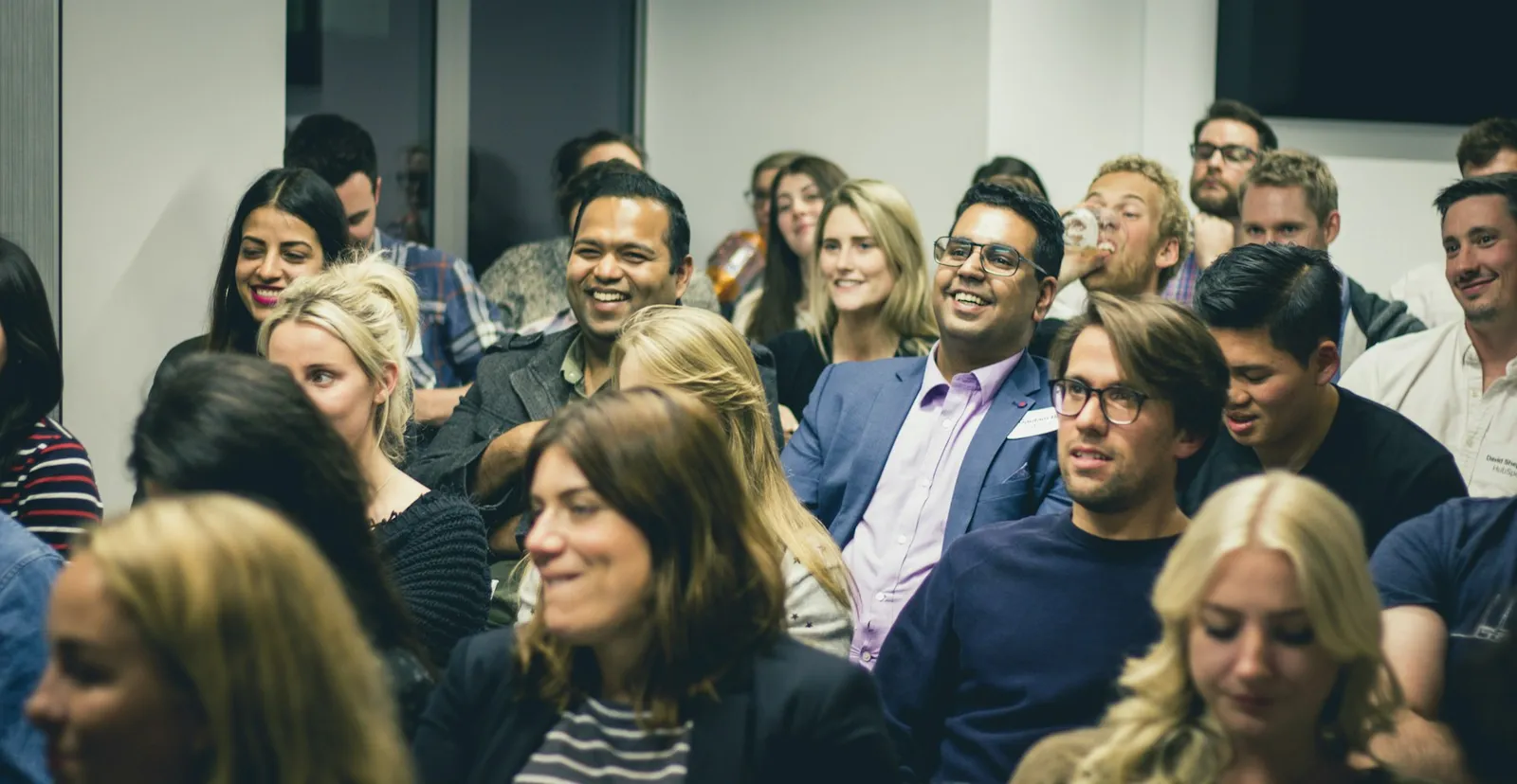 Smiling audience of business owners at a live workshop